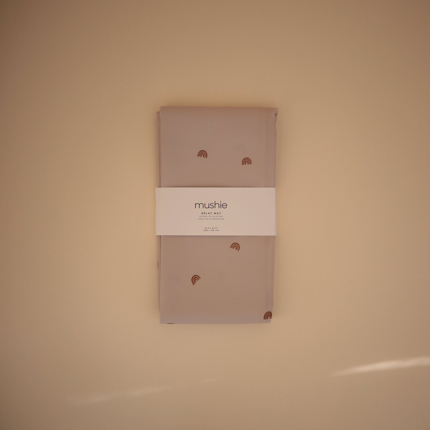 Packaged product with 'mushie' branding on a beige background