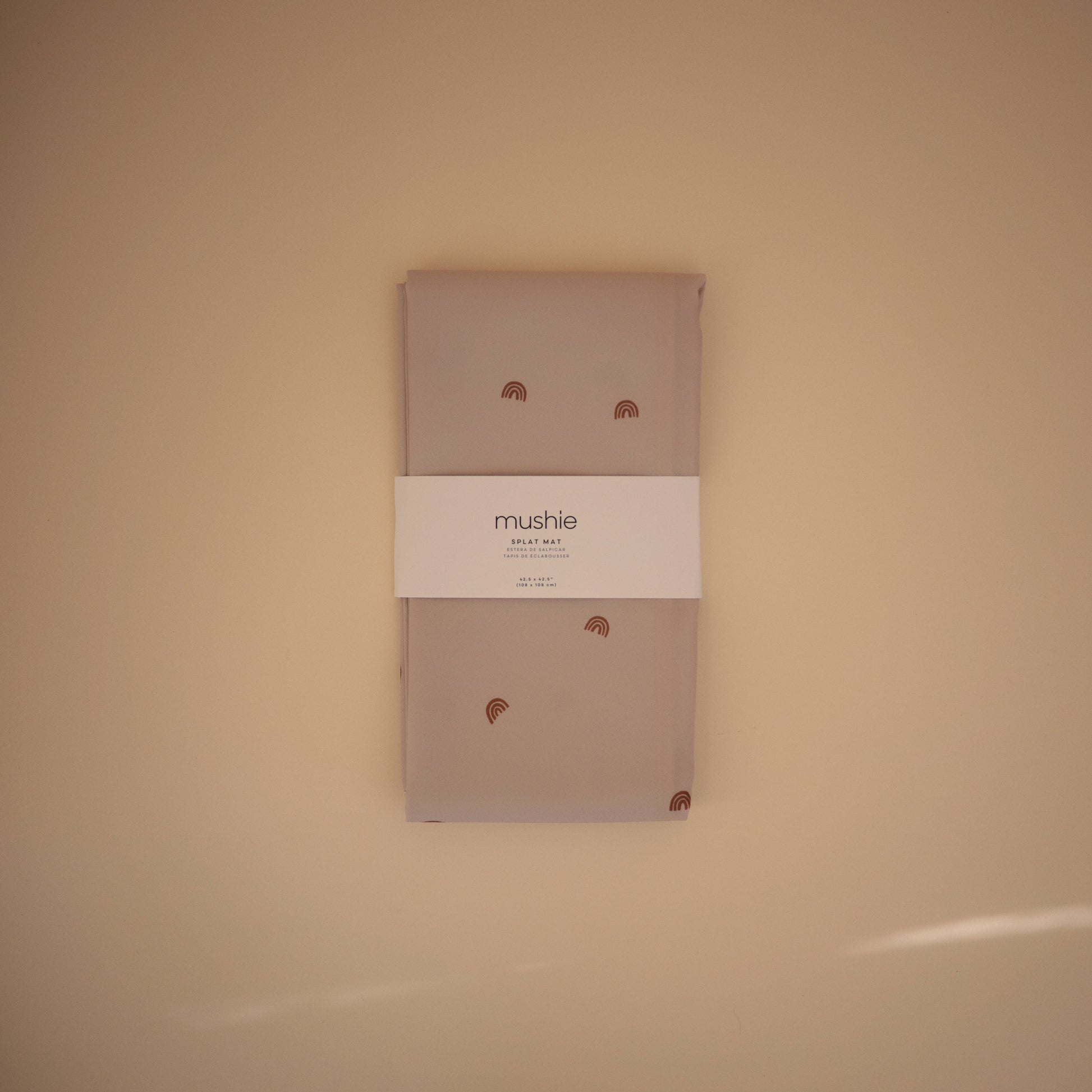 Packaged product with 'mushie' branding on a beige background