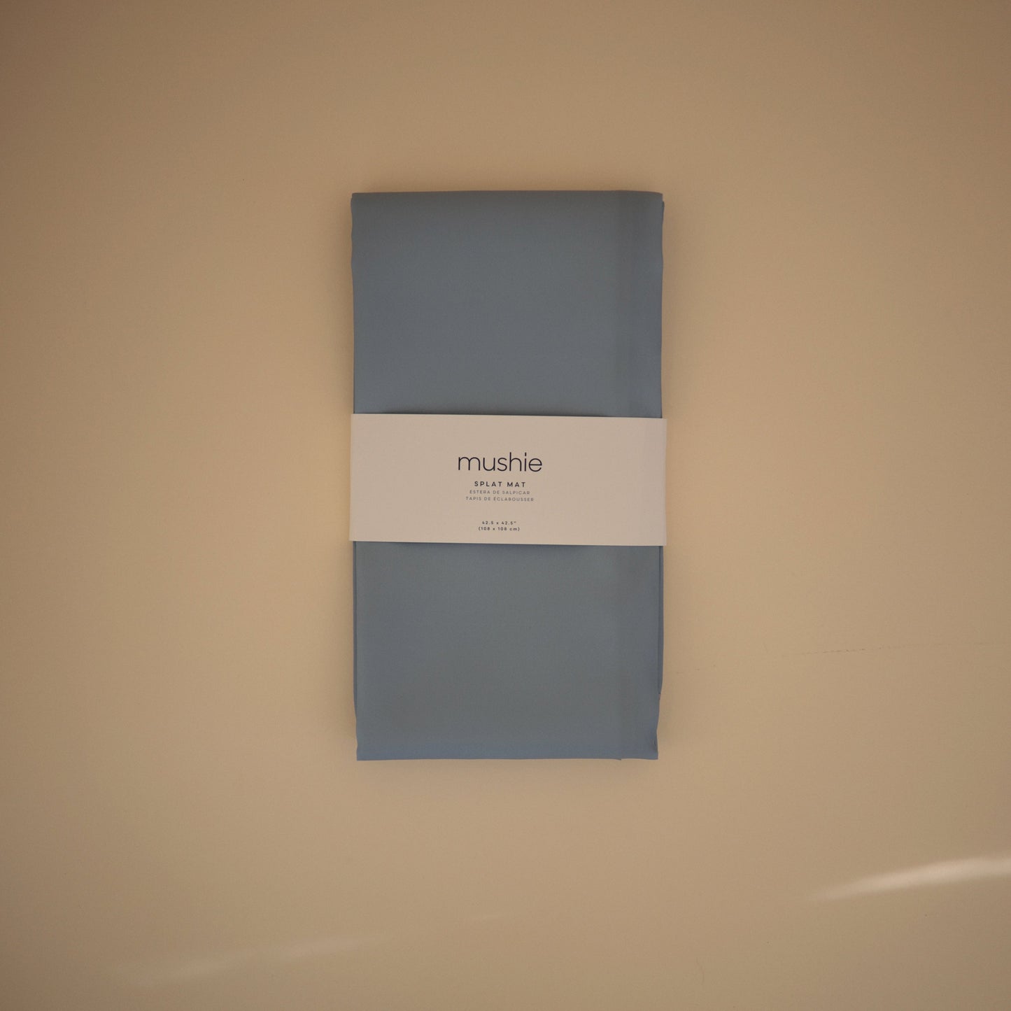 Gray package with a label on a beige background