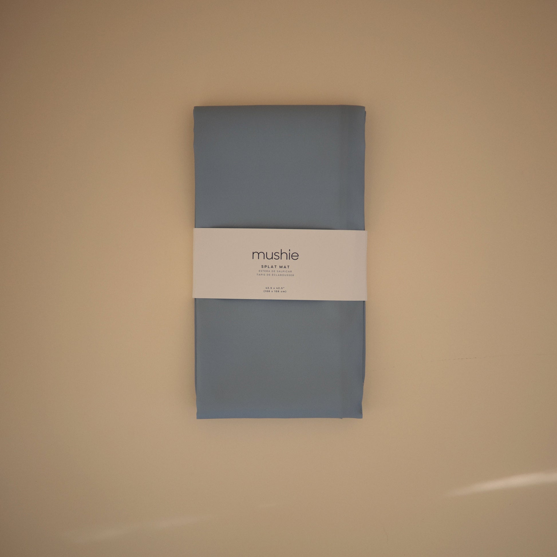 Gray package with a label on a beige background