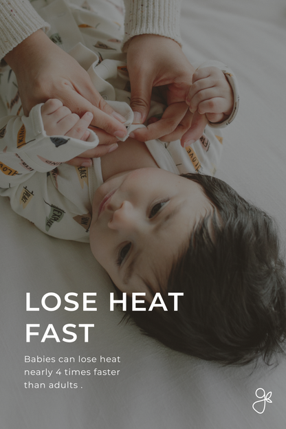 Baby lying on a white blanket with text about heat loss, shown from above.