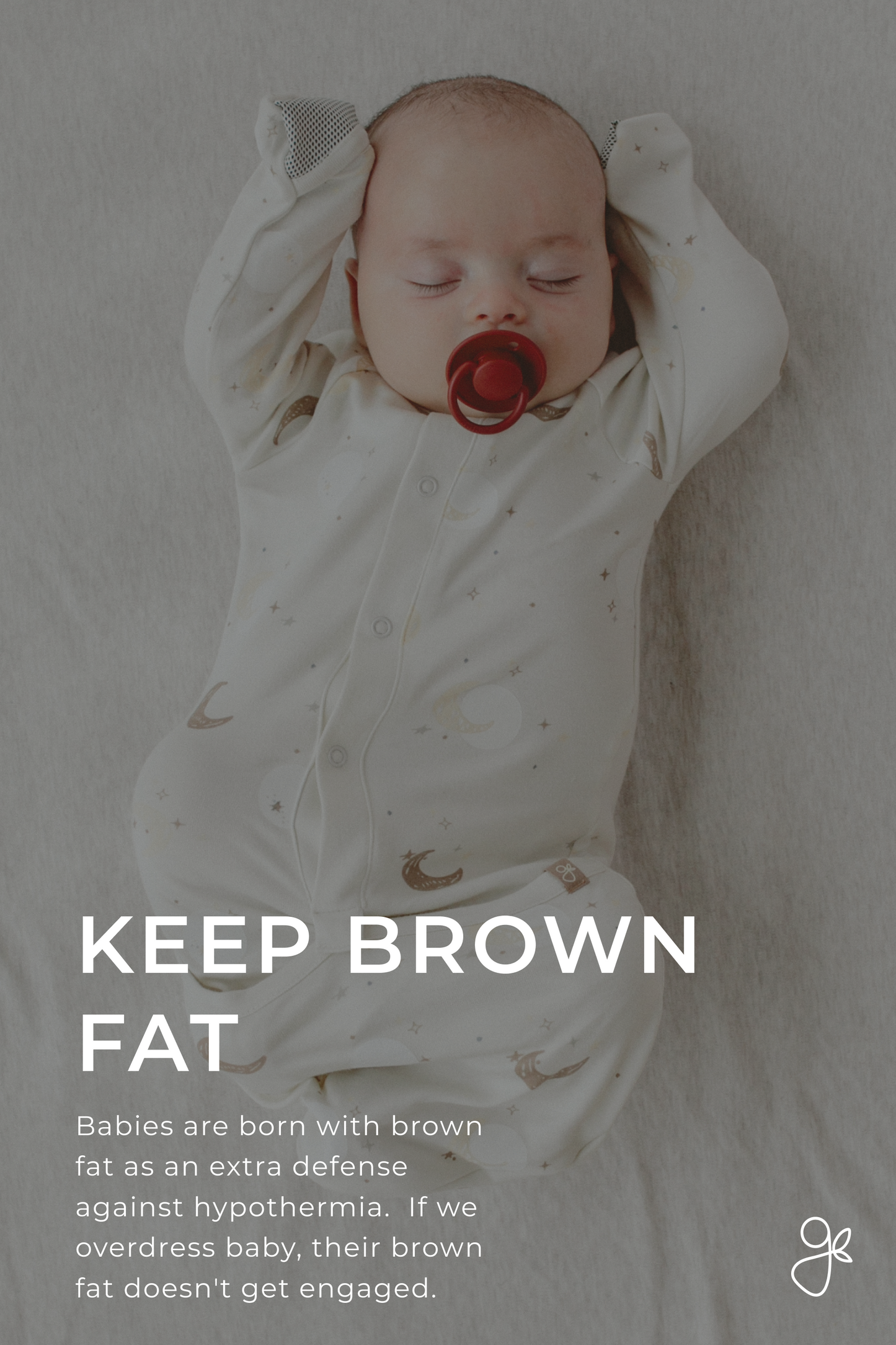 Baby in a white onesie with a pacifier, lying on a light gray surface.