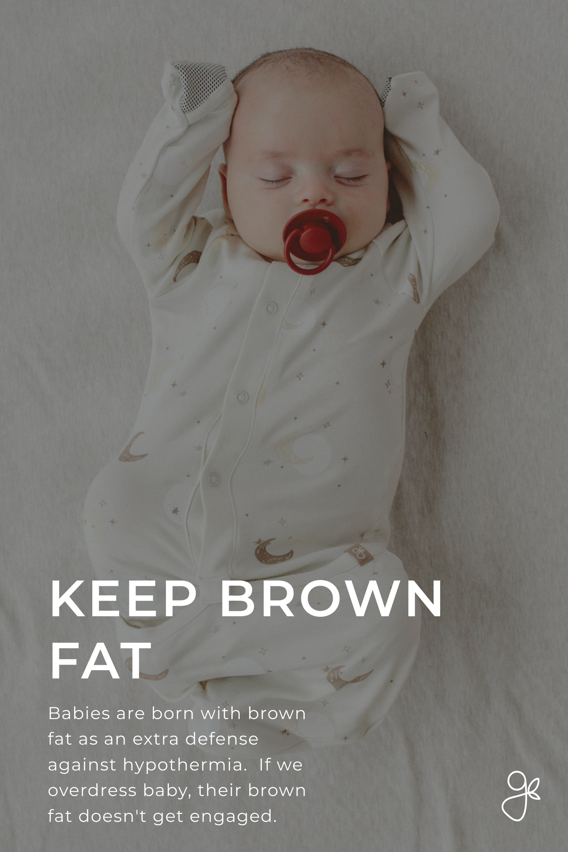 Baby in a white onesie with a pacifier, lying on a light gray surface.
