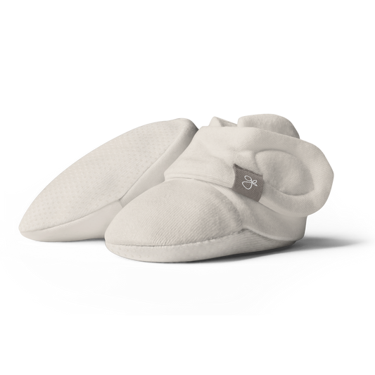Pair of light gray baby booties on a white background