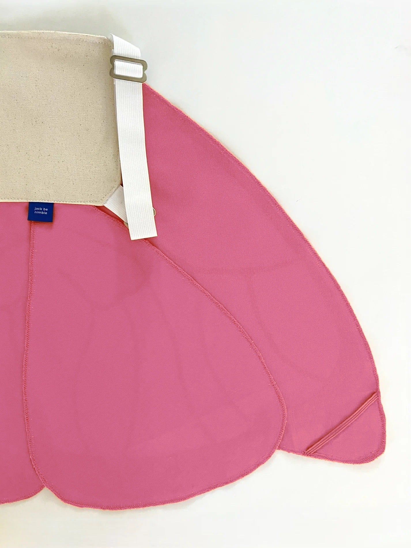 Pink skirt with beige waistband and white strap on a white background