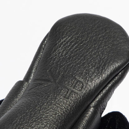 Close-up of a black leather glove with a brand logo on a white background