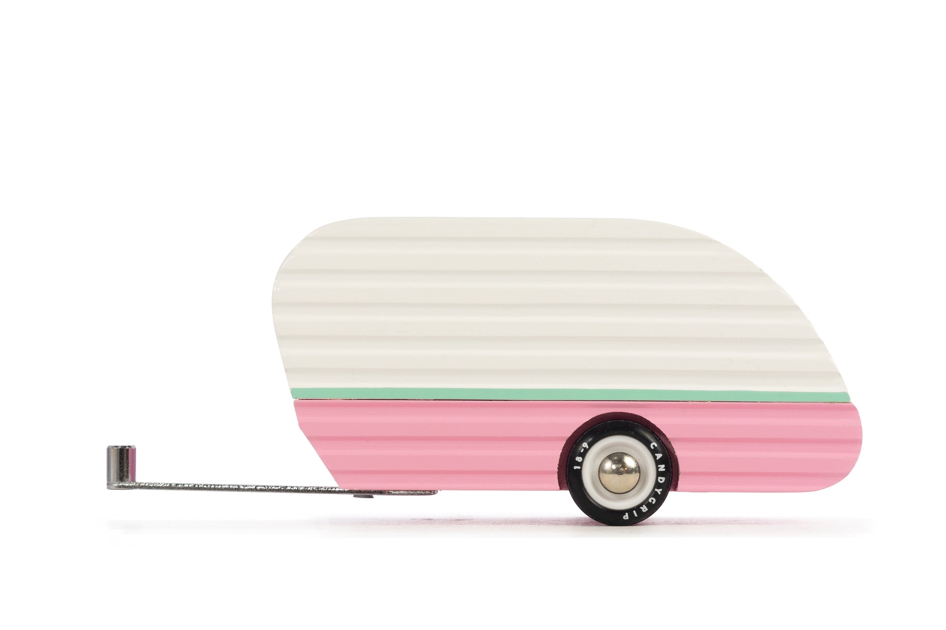 Small model of a vintage-style trailer with a white body and pink sides on a white background