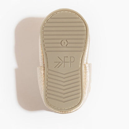 Close-up of a sandal sole with brand logo on a light background