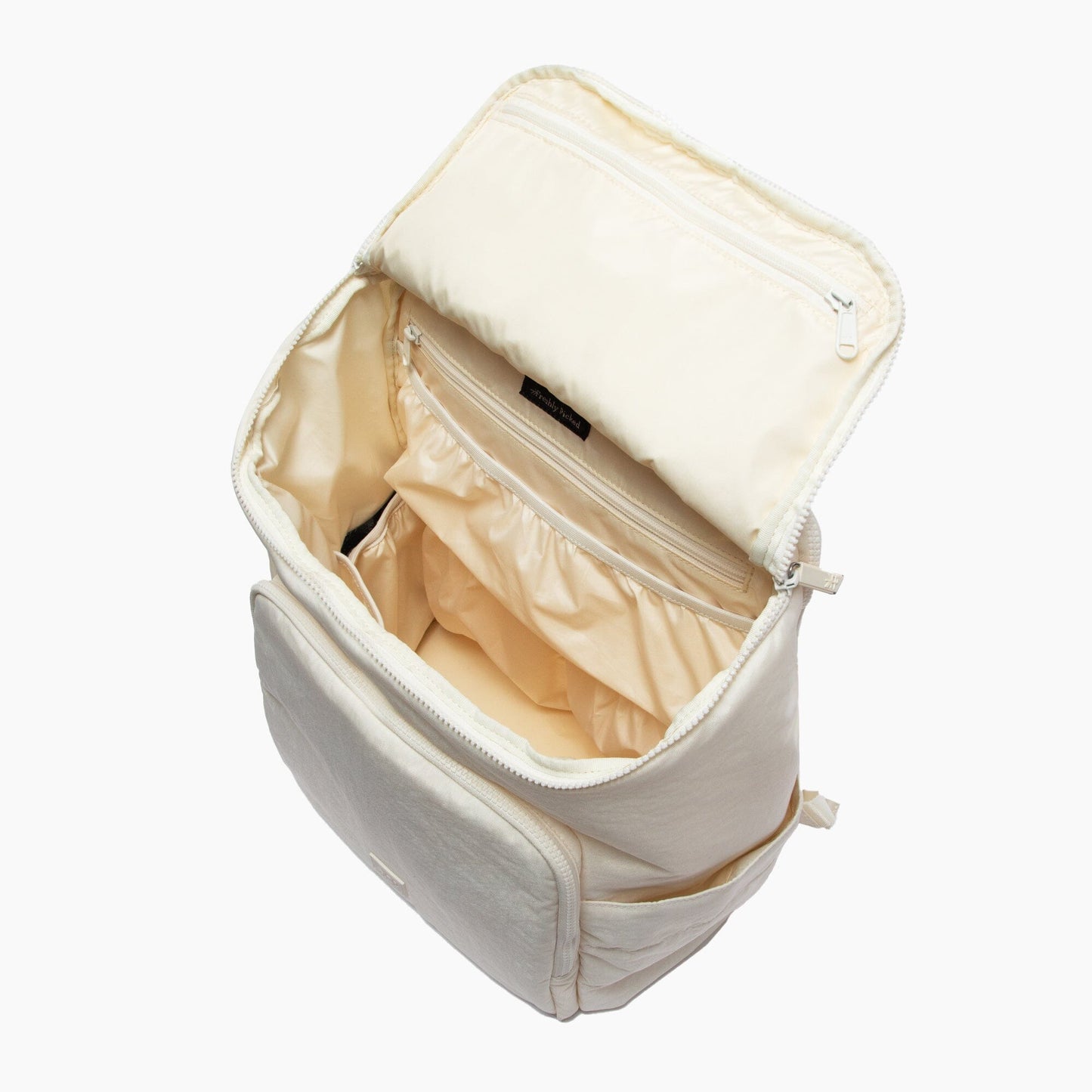 Beige toiletry bag with open compartment on a white background