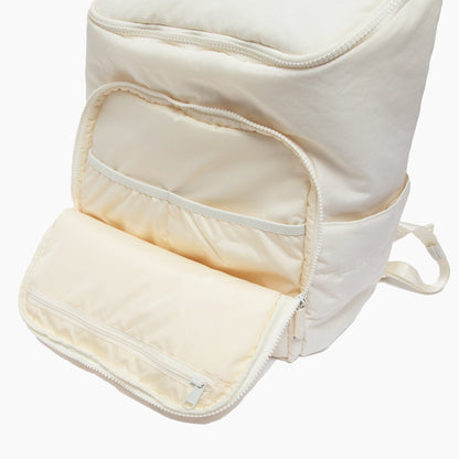 Beige backpack with open front pocket on a white background