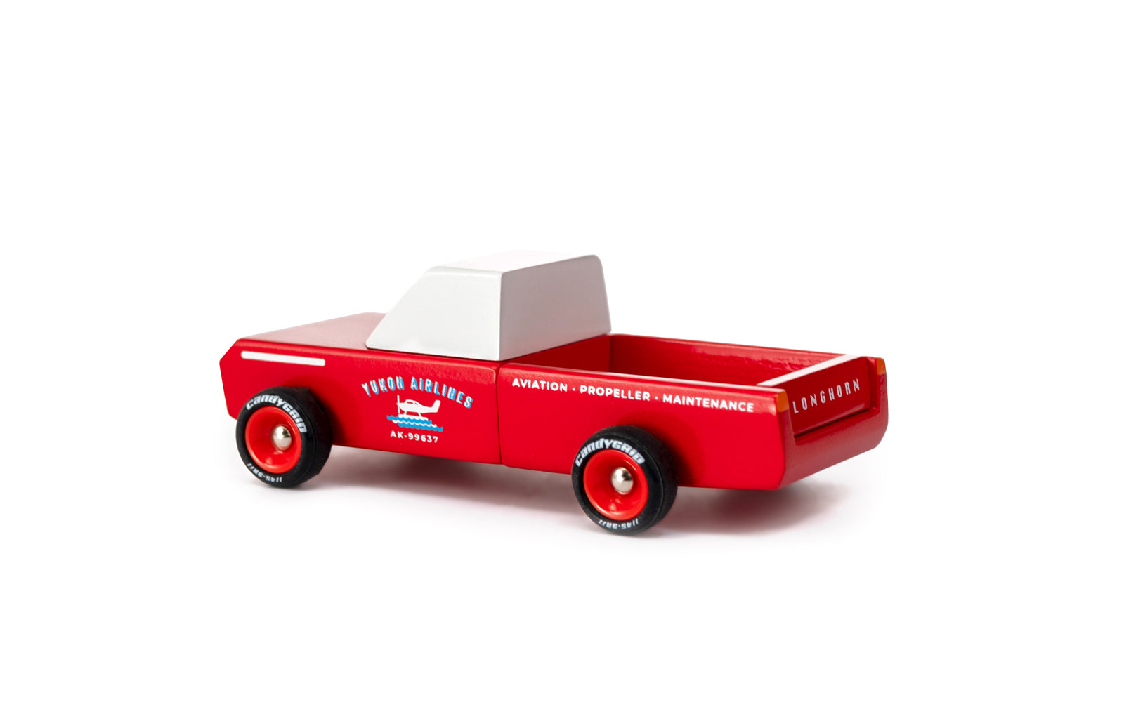 Red toy truck with a white bed on a white background