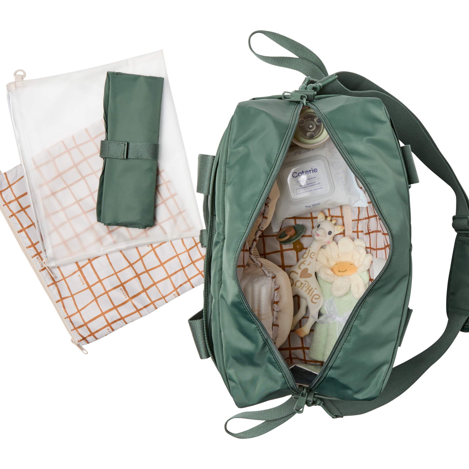 Green baby bag with baby items and a folded blanket on a white background