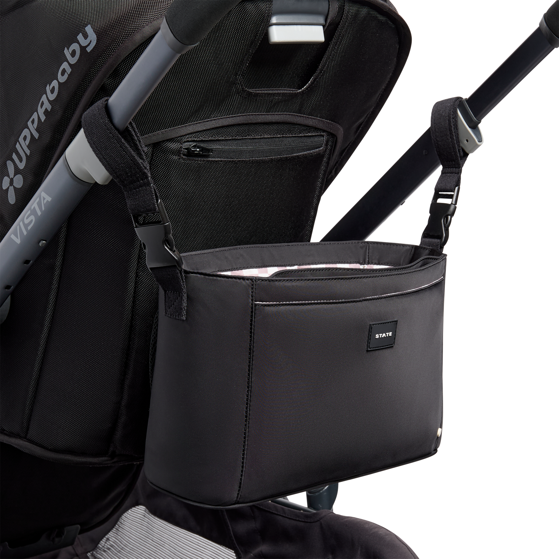 Black stroller organizer attached to a stroller on a white background