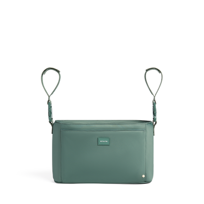 Green crossbody bag with a visible brand logo on a white background