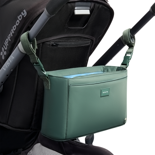 Green stroller organizer attached to a UPPAbaby Vista stroller on a white background