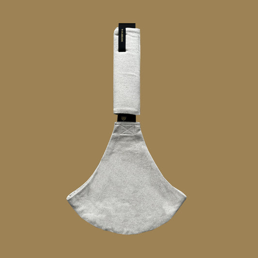 Toddler carrier with a white handle on a beige background