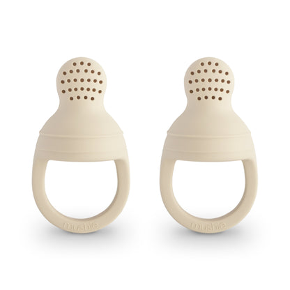 Two beige silicone teething rings on a white background
