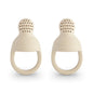 Two beige silicone teething rings on a white background