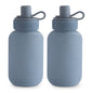 Two blue water bottles with silicone lids on a white background
