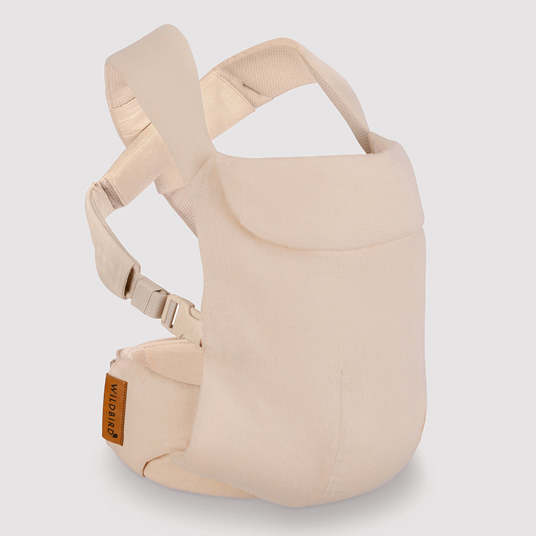 Beige baby carrier on a light gray background