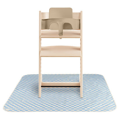 Wooden high chair with beige tray on a blue checkered mat