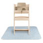 Wooden high chair with beige tray on a blue checkered mat
