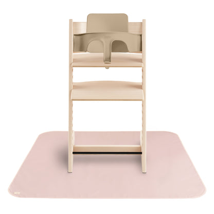 Wooden high chair with beige seat on a pink mat against a white background