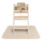 Wooden high chair with beige seat on a matching mat against a white background