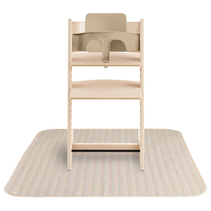 Wooden high chair with beige tray on a striped mat