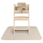 Wooden high chair with beige tray on a striped mat