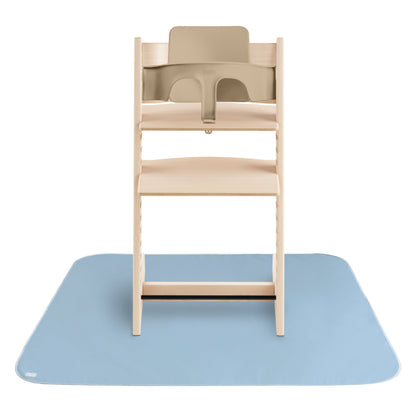 Wooden high chair with beige seat on a blue mat against a white background