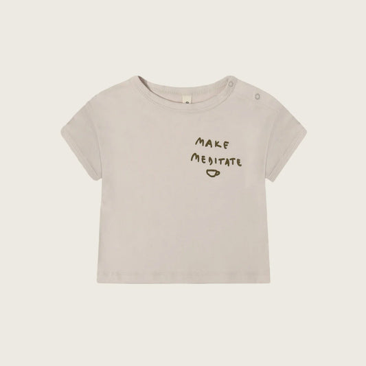 Beige t-shirt with 'MAKE MEDITATE' text on a light beige background