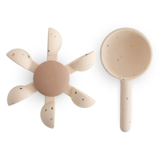 A silicone water wheel and cup on a white background.