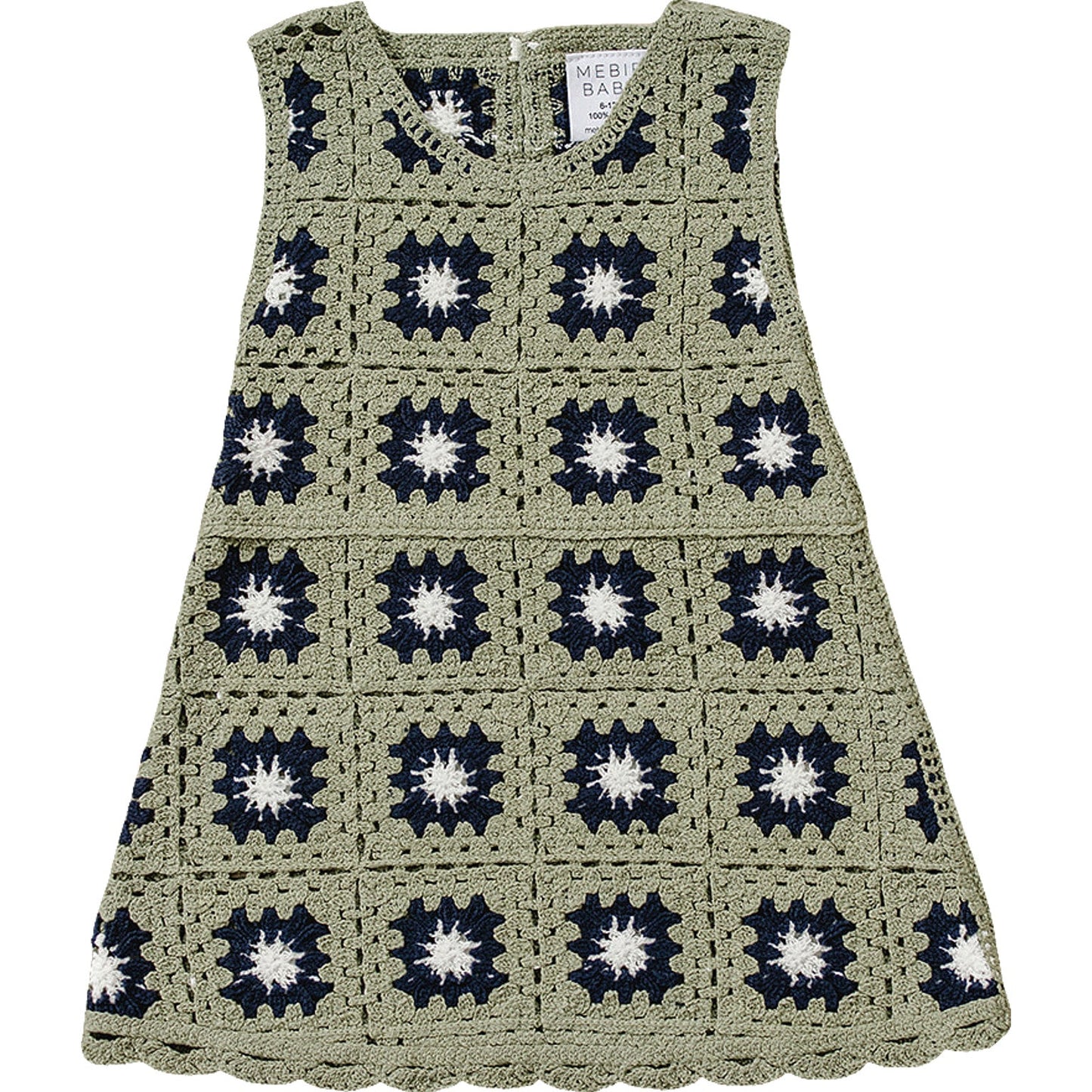 Crocheted dress with a pattern of black and white star shapes on a white background