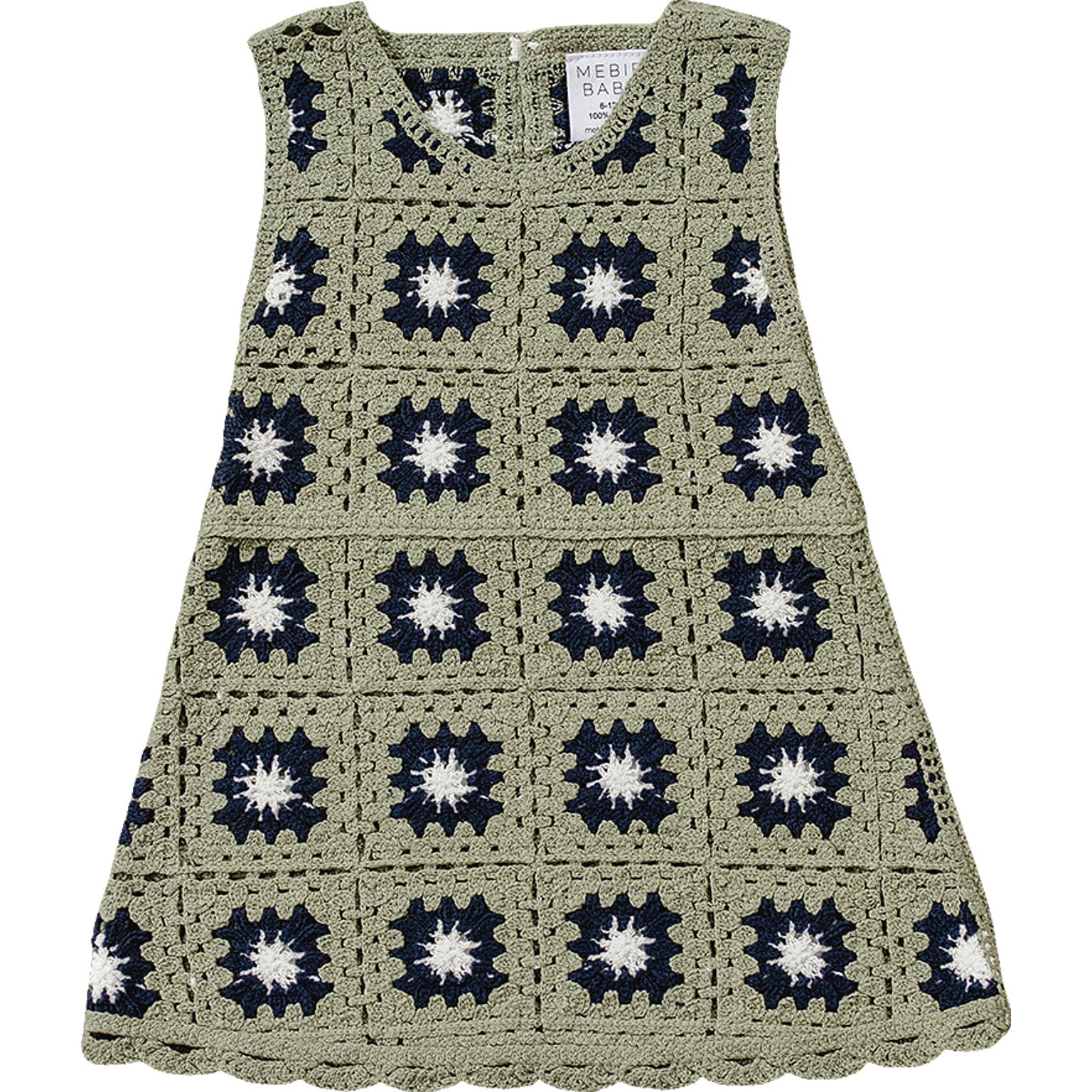 Crocheted dress with a pattern of black and white star shapes on a white background