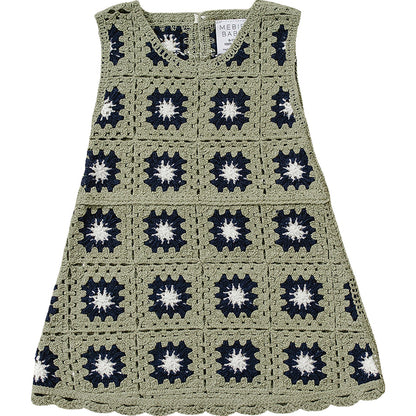 Crocheted dress with a pattern of black and white star shapes on a white background