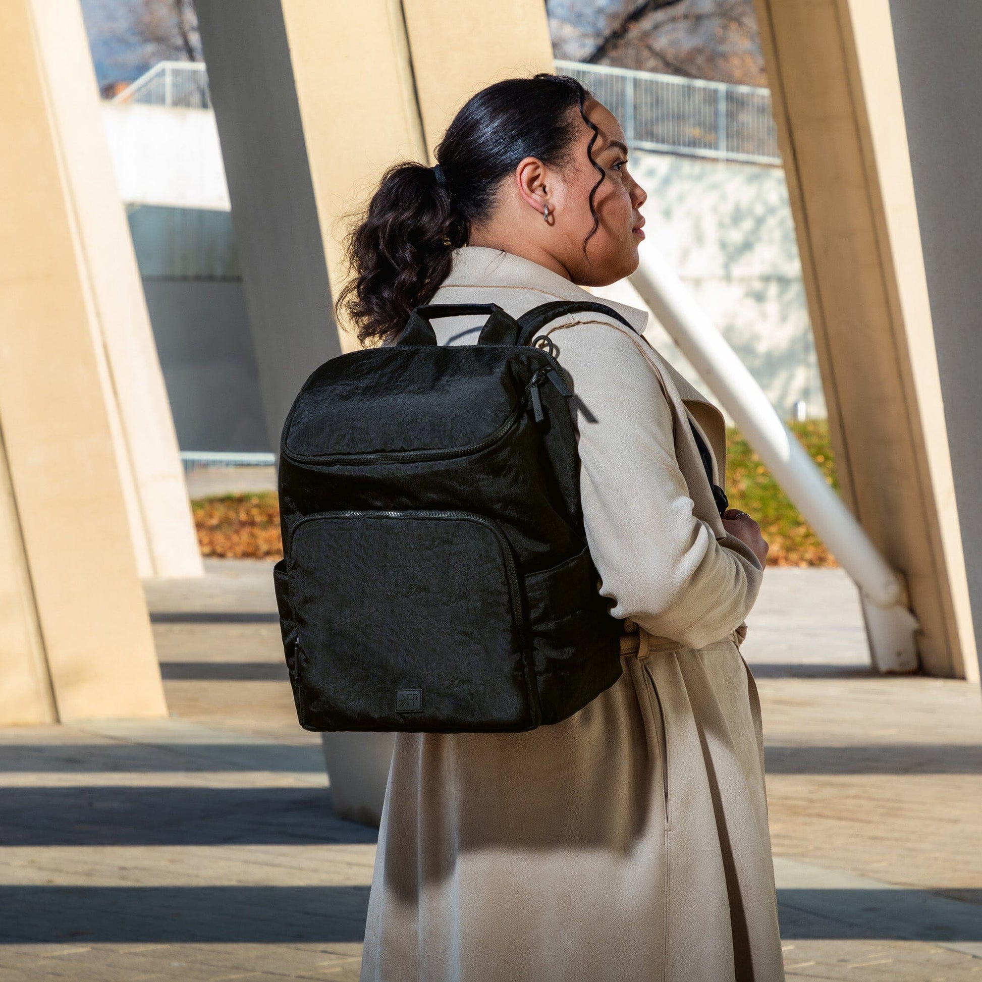 Person wearing a black backpack outdoors