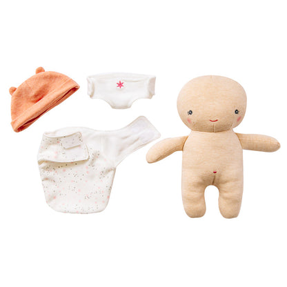 Baby clothing set with a hat, diaper, and soft toy on a white background