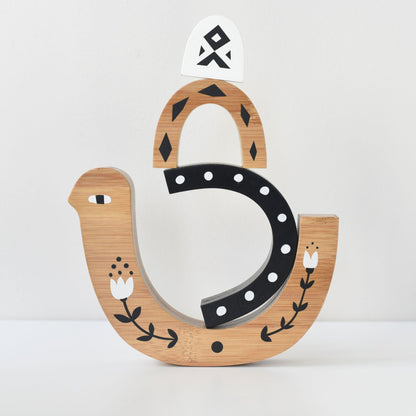 Decorative wooden letter 'S' with horseshoe design on a white background