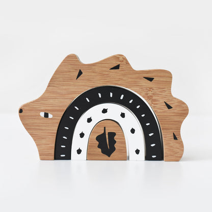 Wooden toy with a bear shape and rainbow design on a white background