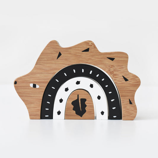 Wooden toy with a bear shape and rainbow design on a white background