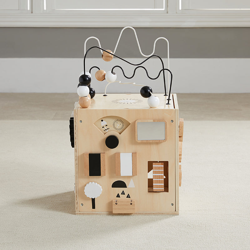 Wooden toy with geometric shapes and wires on a neutral background