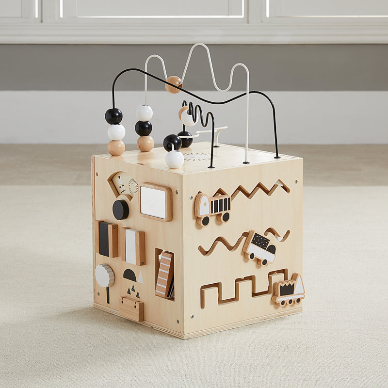 Wooden educational toy with beads and shapes on a light surface