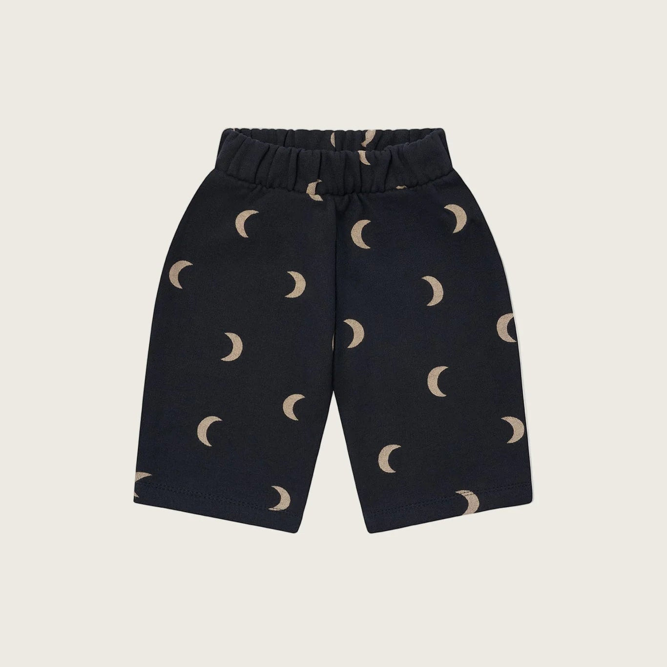 Navy blue pants with moon pattern on a beige background