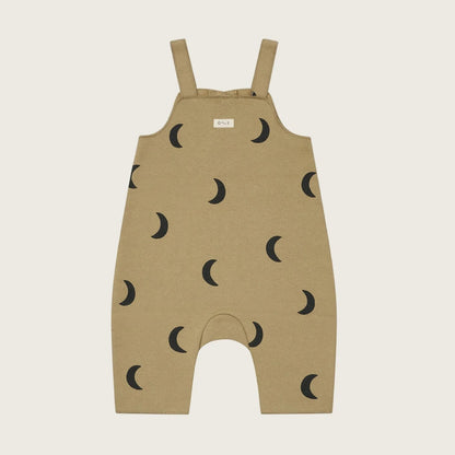 Beige overalls with black moon pattern on a light beige background