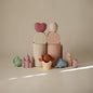 Set of pastel-colored ceramic toys on a beige surface with a neutral background