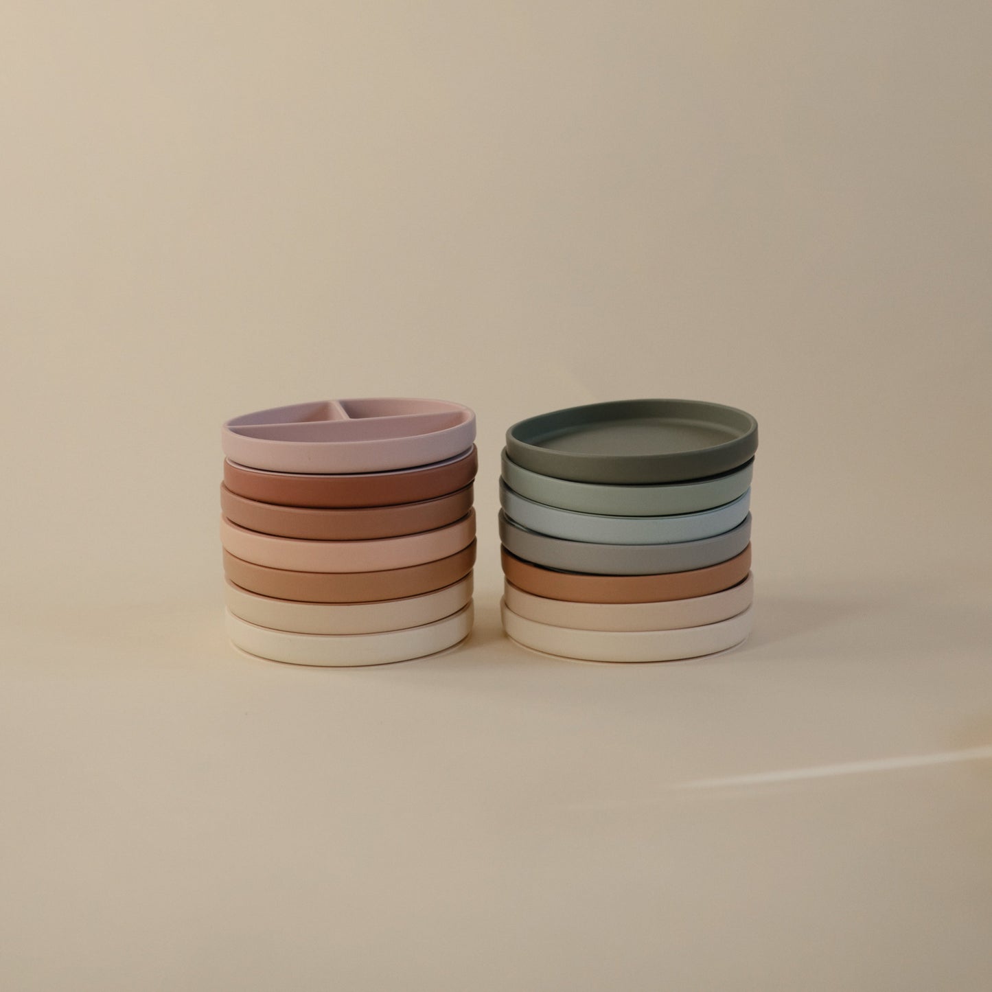 Stacks of colorful ceramic bowls on a beige background