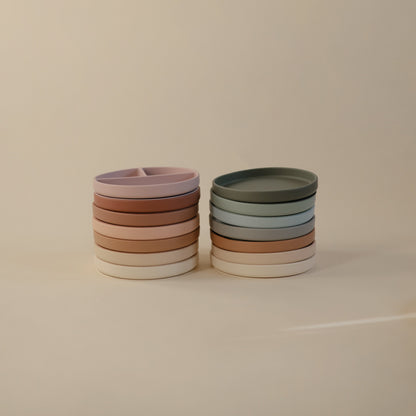Stacks of colorful ceramic bowls on a beige background