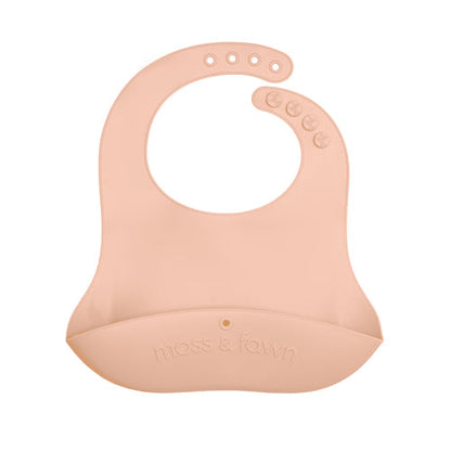 Pink silicone bib with 'moss & town' branding on a white background