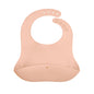 Pink silicone bib with 'moss & town' branding on a white background